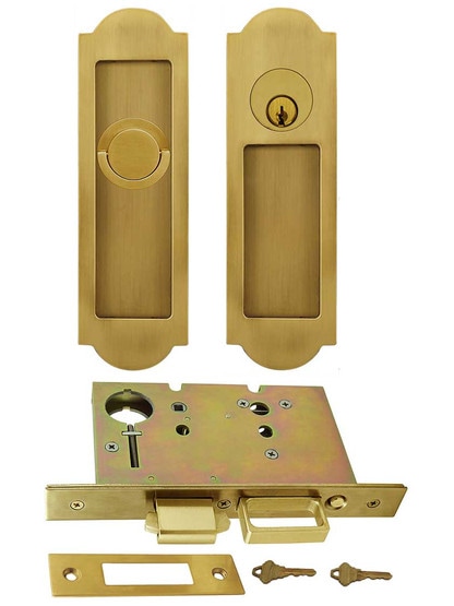 Premium Keyed Pocket-Door Mortise Lock Set with Arched Pulls in Aged Brass.